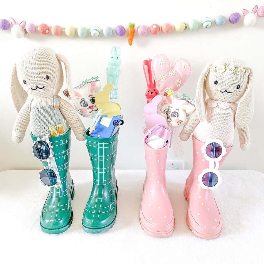 Blue green pastel boots and light pink boots with sun glasses, bunny stuffed animal 