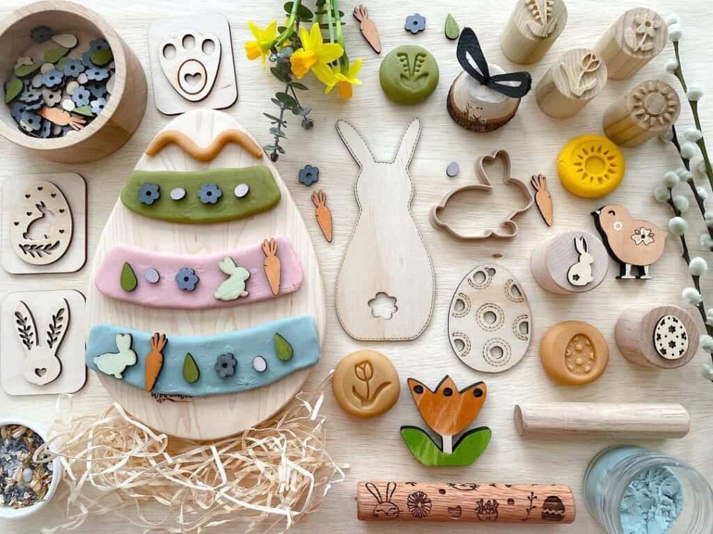 Sensory Easter theme basket filled with bunny feet stamps, wooden toys shapes like bunny, carrot, flower  